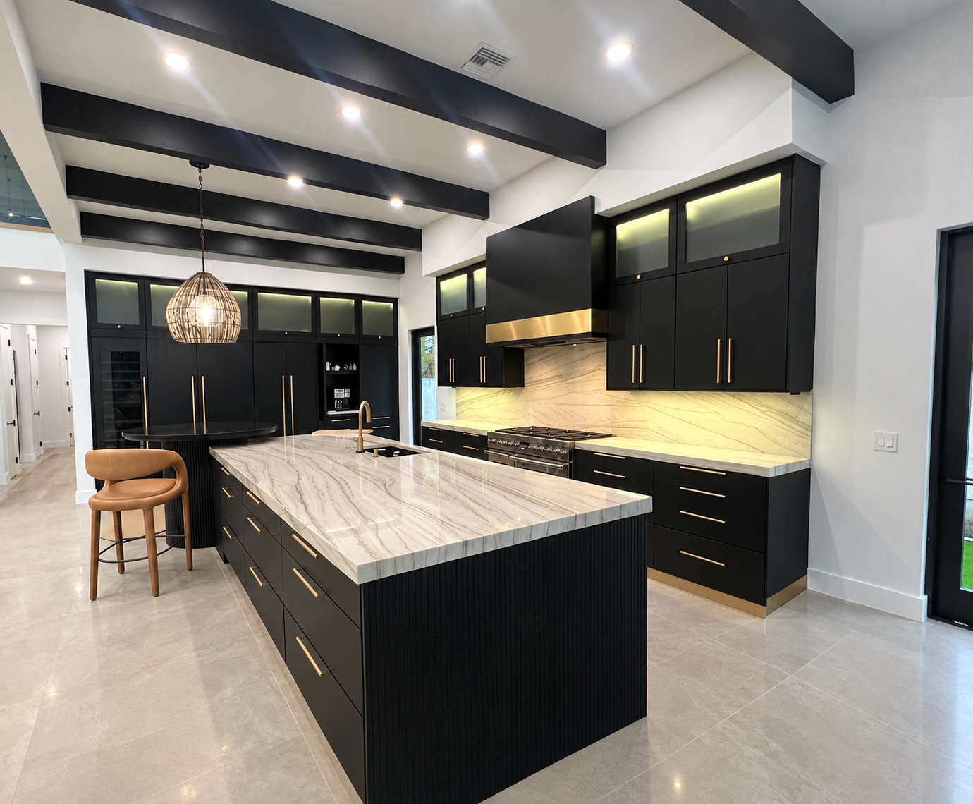 Black Kitchen with Tajmahal stone Countertops and Beams